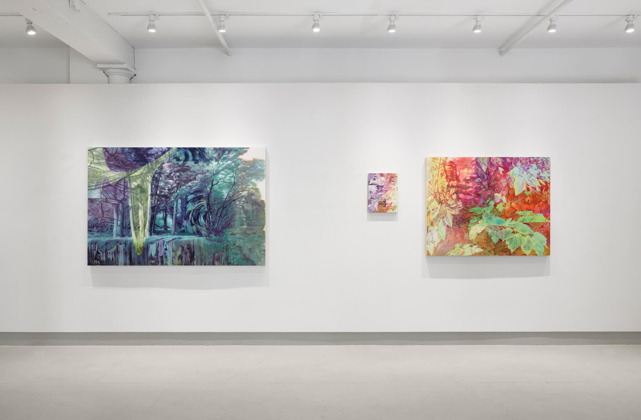 Installation view of three paintings in Cristi Rinklin's "Ecologies of Perception" exhibition. The paintings utilize psychedelic blues, greens, oranges, and pinks to create dream-like versions of landscapes occurring in the natural world.